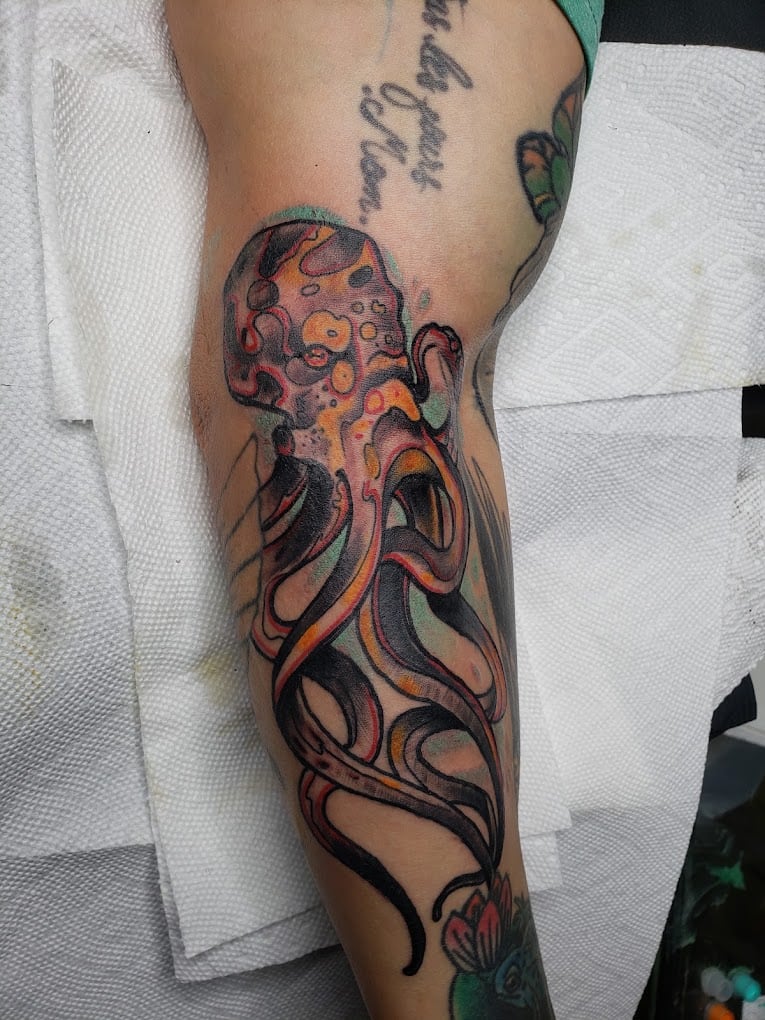 Neo-traditional color octopus tattoo on forearm, done at Soul Stone Tattoo